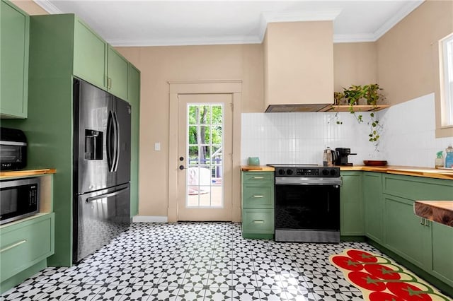 kitchen featuring stainless steel appliances, green cabinetry, butcher block counters, light flooring, and crown molding