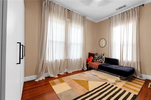 sitting room with baseboards and wood finished floors