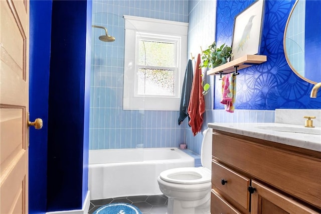 bathroom with tile patterned floors, toilet, vanity, shower / bathtub combination, and wallpapered walls