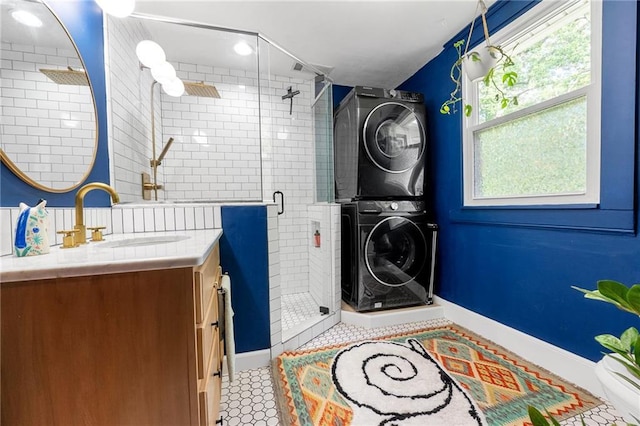 clothes washing area featuring stacked washer / dryer and plenty of natural light