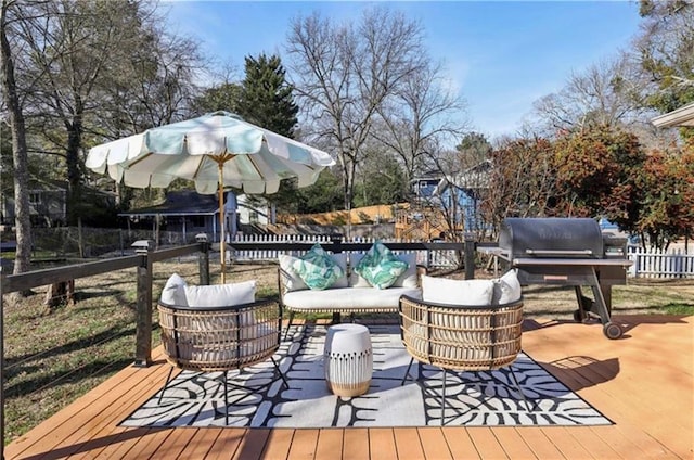 wooden deck with an outdoor living space, fence, and area for grilling