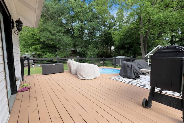 wooden deck with view of scattered trees and fence