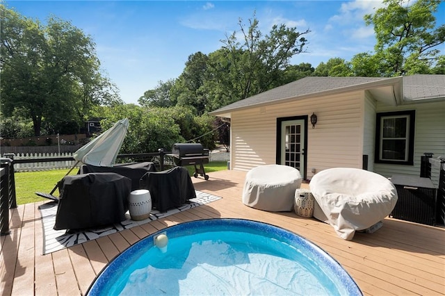 view of pool featuring a deck and fence