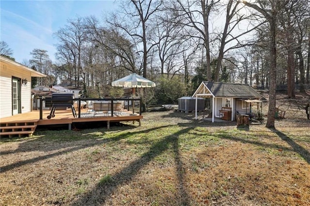 view of green lawn featuring an outdoor structure and a wooden deck