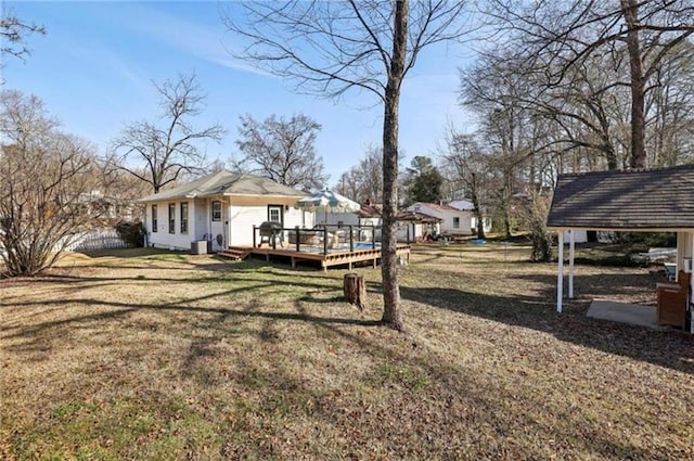 view of grassy yard with a deck