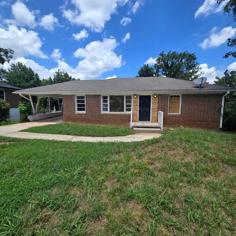 ranch-style house with a front yard and a carport