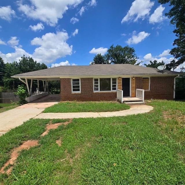 ranch-style house with a front yard and a carport