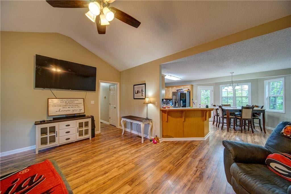 172 Laurel Dr NE, Calhoun, GA 30701 - living area with light wood-style flooring, ceiling fan, and vaulted ceiling