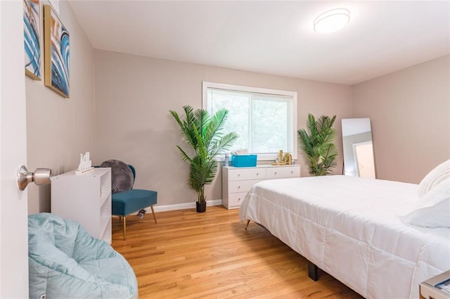 bedroom with baseboards and light wood-style flooring