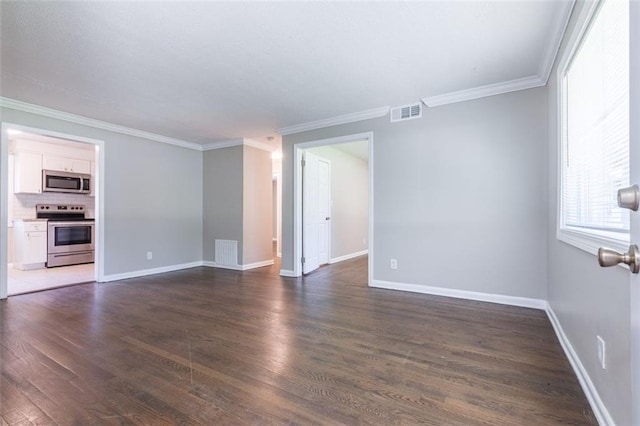 unfurnished room featuring visible vents, baseboards, dark wood finished floors, and crown molding