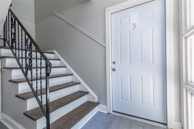 staircase with tile patterned flooring and baseboards