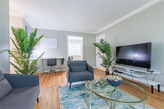 living room featuring wood finished floors, baseboards, and ornamental molding