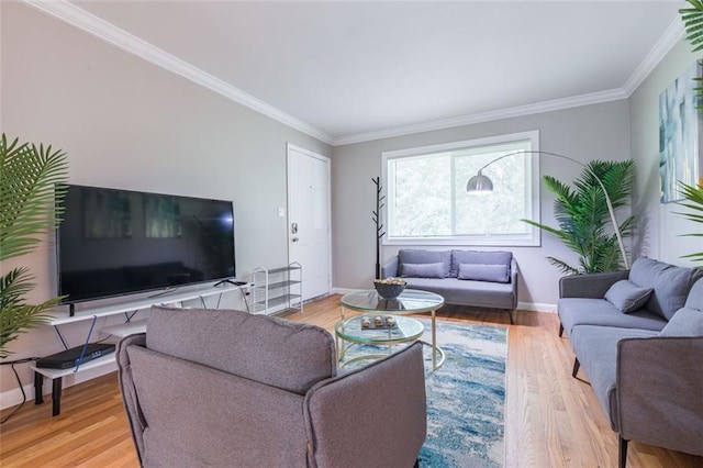 living room with wood finished floors, baseboards, and ornamental molding