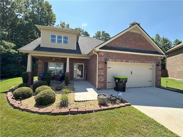 craftsman house with a front yard and a garage