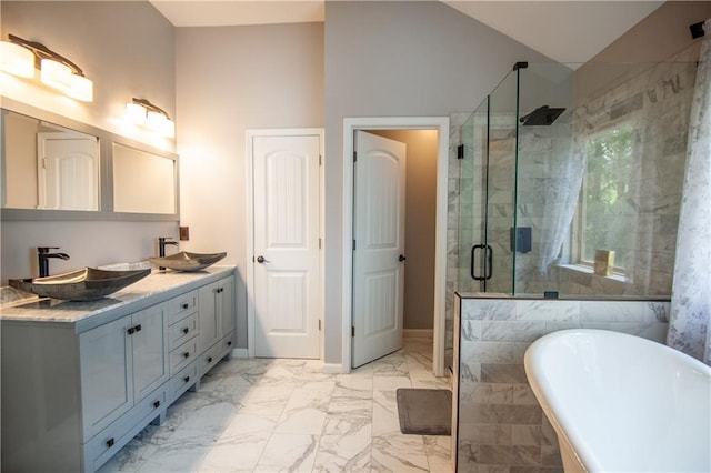 bathroom featuring a shower stall, marble look tiles, a freestanding tub, double vanity, and baseboards