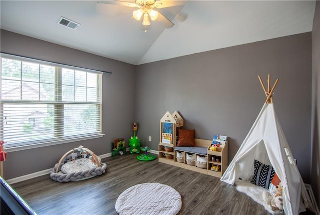 recreation room featuring lofted ceiling, wood finished floors, a ceiling fan, and baseboards