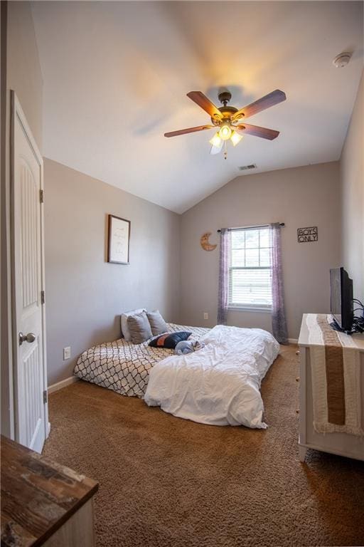 carpeted bedroom featuring lofted ceiling, baseboards, and a ceiling fan