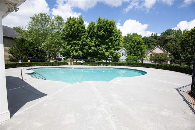 community pool featuring fence and a patio area