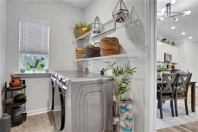 washroom featuring washing machine and clothes dryer, laundry area, recessed lighting, light wood-style floors, and an inviting chandelier