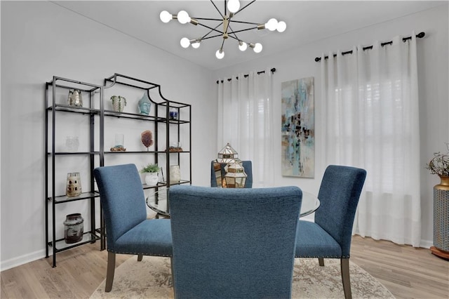 office area featuring baseboards, an inviting chandelier, and wood finished floors