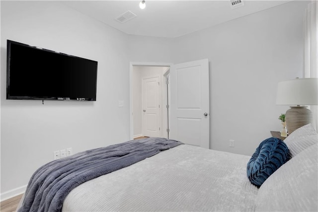 bedroom with visible vents and baseboards