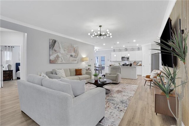 living room featuring light wood finished floors, recessed lighting, crown molding, and an inviting chandelier