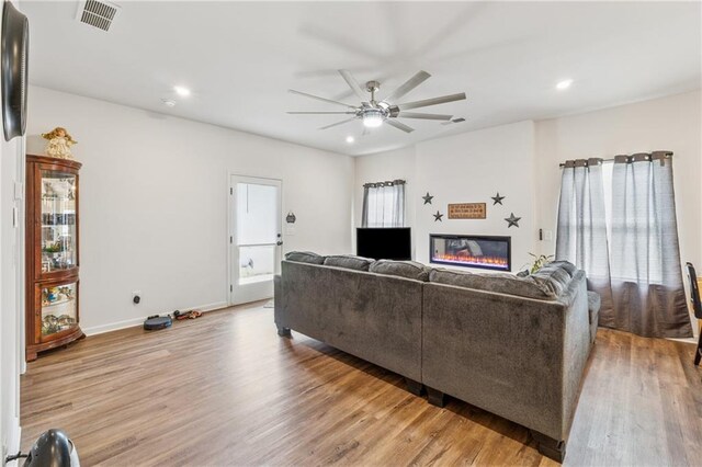 101 Marion Dr, Cartersville, GA 30120 - living room featuring wood finished floors, ceiling fan, recessed lighting, and a glass covered fireplace