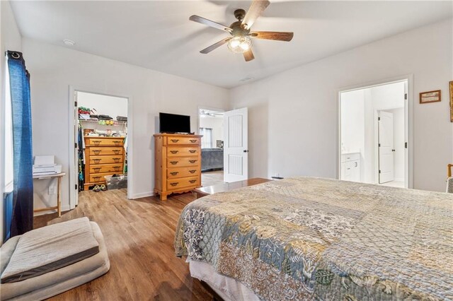 101 Marion Dr, Cartersville, GA 30120 - bedroom featuring a spacious closet, light wood-style flooring, a closet, a ceiling fan, and ensuite bathroom