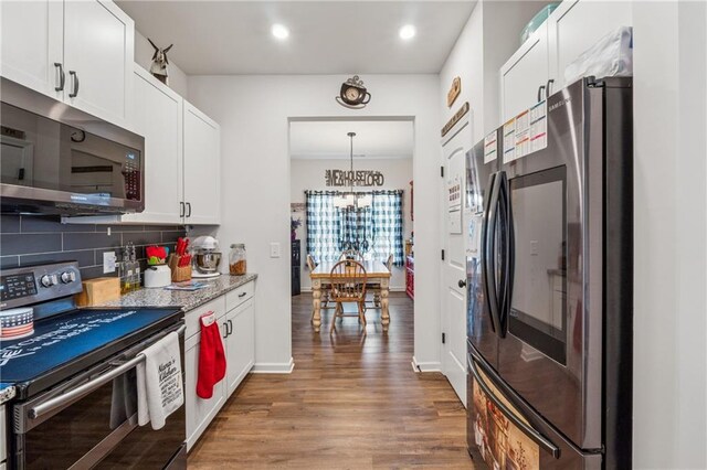 101 Marion Dr, Cartersville, GA 30120 - kitchen featuring stainless steel appliances, tasteful backsplash, white cabinets, wood finished floors, and a chandelier
