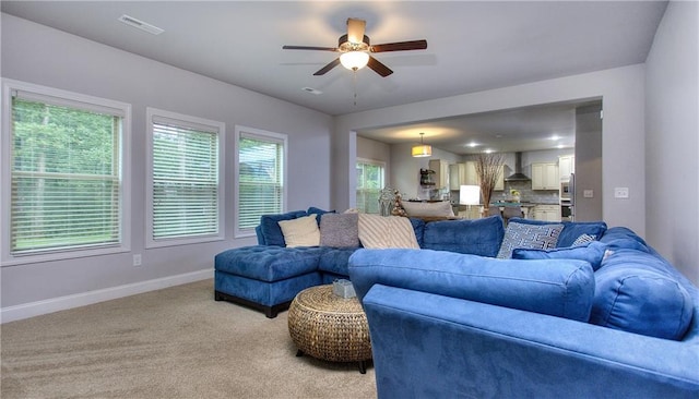 116 Chorley Run, Ellenwood, GA 30294 - living area with a ceiling fan and light carpet