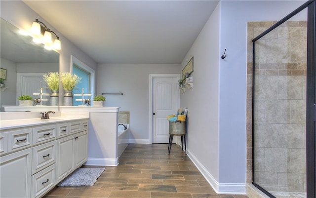116 Chorley Run, Ellenwood, GA 30294 - bathroom featuring vanity, a stall shower, a garden tub, and wood finished floors