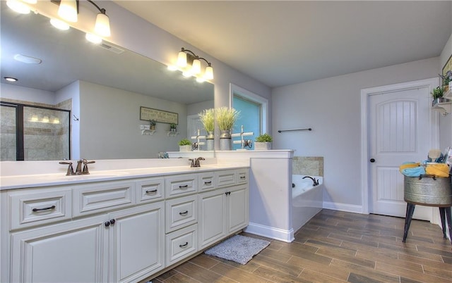 116 Chorley Run, Ellenwood, GA 30294 - full bathroom with double vanity, a bath, a stall shower, and wood finished floors