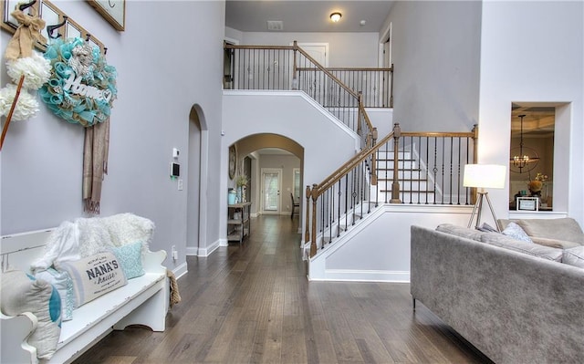 116 Chorley Run, Ellenwood, GA 30294 - entryway with arched walkways, wood finished floors, stairs, a high ceiling, and a chandelier