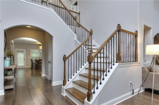 116 Chorley Run, Ellenwood, GA 30294 - stairs with wood-type flooring, a high ceiling, and arched walkways