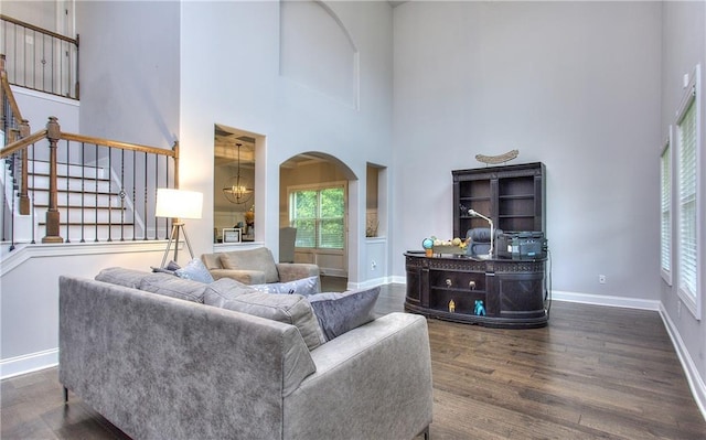 116 Chorley Run, Ellenwood, GA 30294 - living room with a towering ceiling, arched walkways, healthy amount of natural light, dark wood-type flooring, and stairway