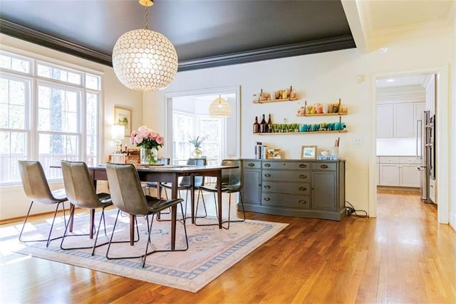 dining room featuring ornamental molding, a wealth of natural light, and wood finished floors