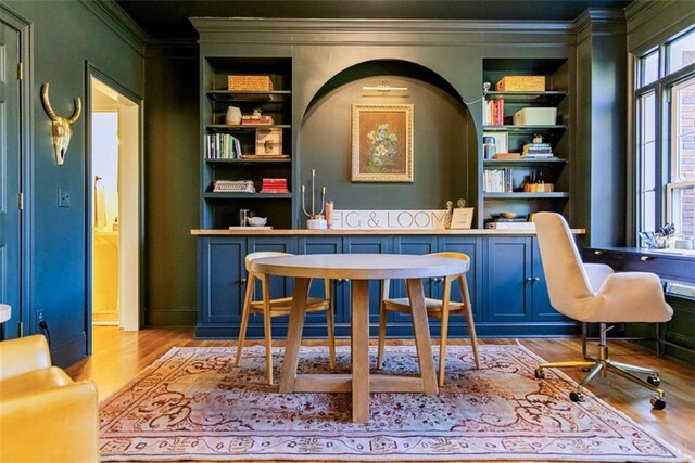 bar featuring ornamental molding, built in shelves, and wood finished floors