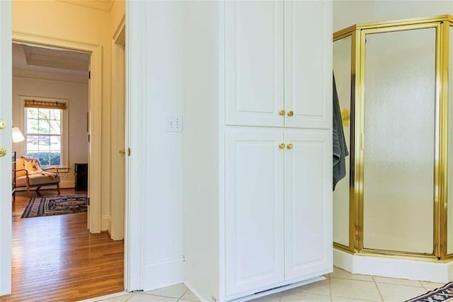 hallway with light tile patterned floors and baseboards