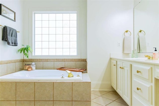 bathroom with tile patterned floors, a bath, and vanity
