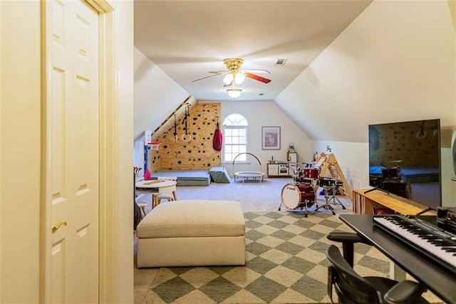 interior space featuring visible vents, ceiling fan, vaulted ceiling, and carpet