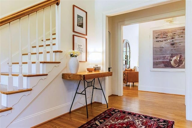 stairway featuring baseboards and wood finished floors
