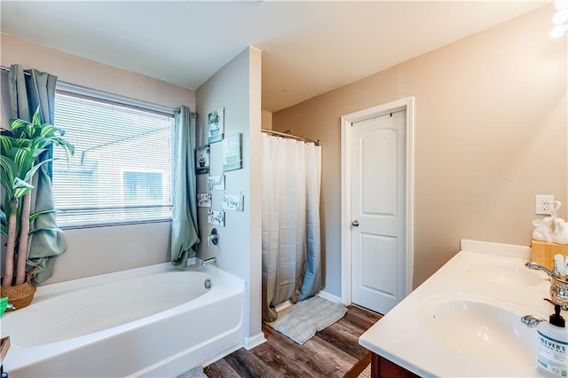1574 Leonard St, Hampton, GA 30228 - full bathroom with a garden tub, wood finished floors, a shower with shower curtain, and double vanity