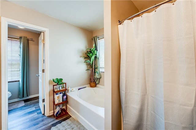 1574 Leonard St, Hampton, GA 30228 - bathroom featuring wood finished floors, a bath, and curtained shower