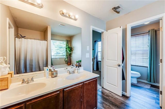 1574 Leonard St, Hampton, GA 30228 - bathroom with wood finished floors, double vanity, and a bath