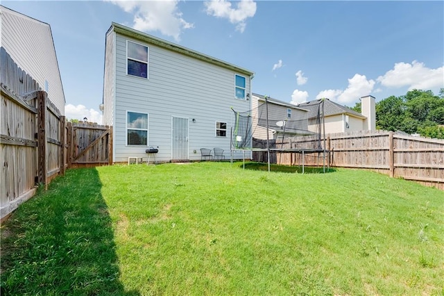 1574 Leonard St, Hampton, GA 30228 - rear view of property with a trampoline and a fenced backyard
