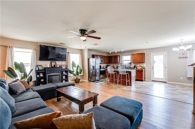 1574 Leonard St, Hampton, GA 30228 - living area with light wood finished floors, a chandelier, and ceiling fan
