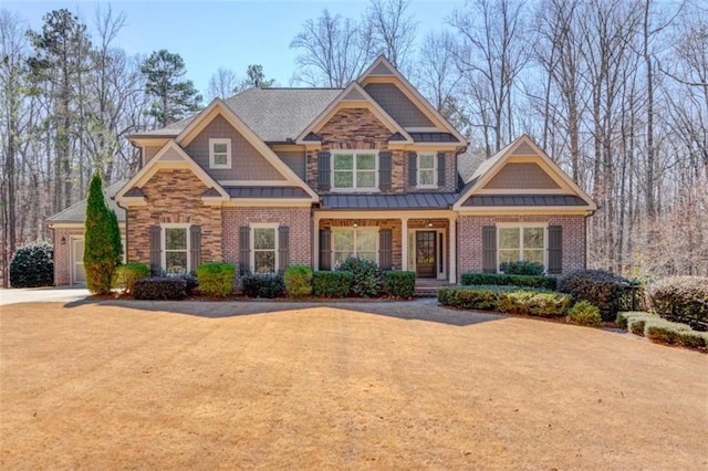 craftsman house featuring a standing seam roof, brick siding, metal roof, and concrete driveway