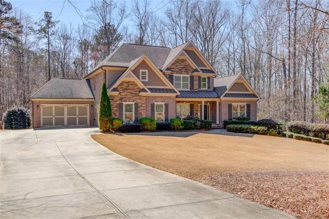 craftsman-style home with an attached garage, a front yard, a standing seam roof, metal roof, and driveway