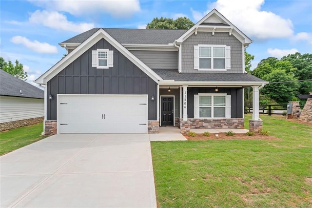 craftsman inspired home with a front lawn, stone siding, a shingled roof, board and batten siding, and concrete driveway