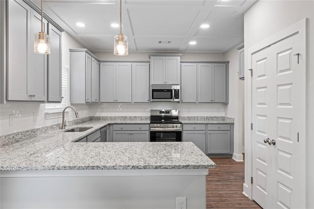 kitchen featuring dark wood-type flooring, gray cabinets, a sink, coffered ceiling, and stainless steel appliances